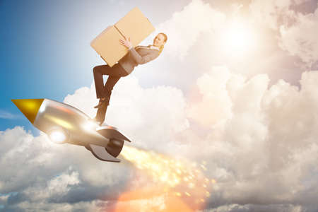 Woman flying rocket and delivering boxesの写真素材
