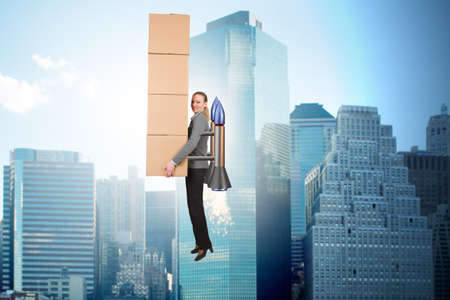 Woman in fast box delivery service on rocketの写真素材