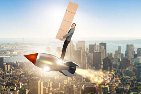 Woman flying rocket and delivering boxesの写真素材