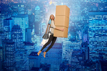 Woman in fast box delivery service on rocketの写真素材