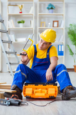 Young man assembling wood palletの写真素材