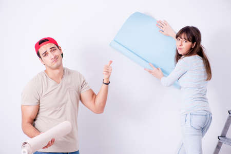 Young family doing renovation at home with new wallpaperの写真素材