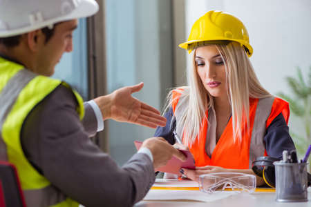 Construction workers having discussion in office before startingの写真素材