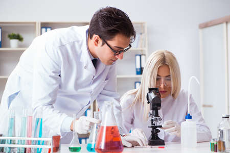 Two chemists having discussion in lab