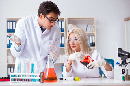Woman female doctor looking at blood samples in bagの写真素材