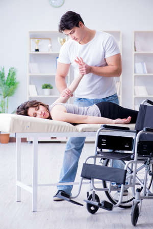 Patient undergoing rehabilitation recovery programme with doctorの写真素材