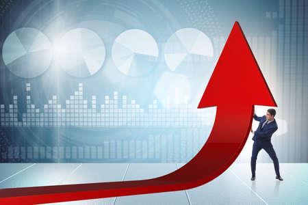 Businessman supporting growtn in economy on chart graphの写真素材