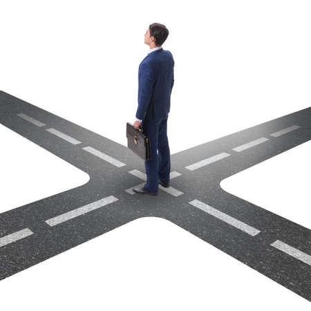 Young businessman at crossroads in uncertainty conceptの写真素材
