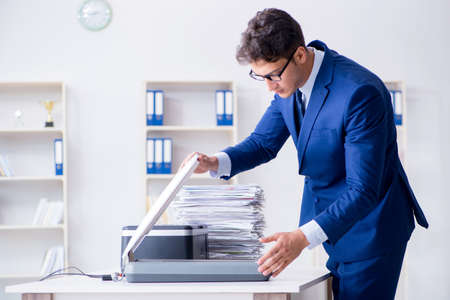 Businessman making copies in copying machineの写真素材