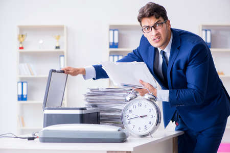 Businessman making copies in copying machine