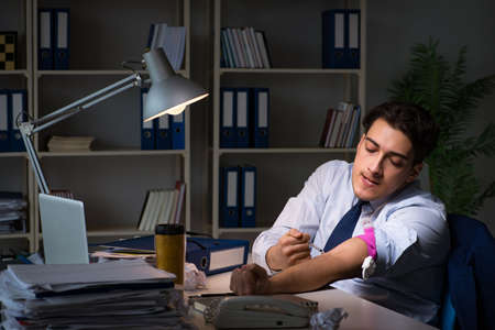 Employee relieving stress from overtime with drugs narcoticsの写真素材