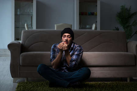 Young man in agony having problems with narcoticsの写真素材