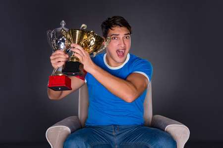 Man watching sports on gray backgroundの写真素材