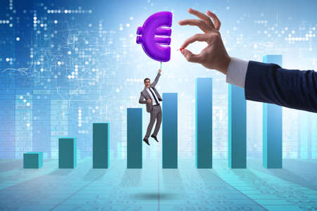 Businessman flying on euro sign inflatable balloonの写真素材