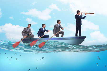 Team of businessmen in teamwork concept with boatの写真素材