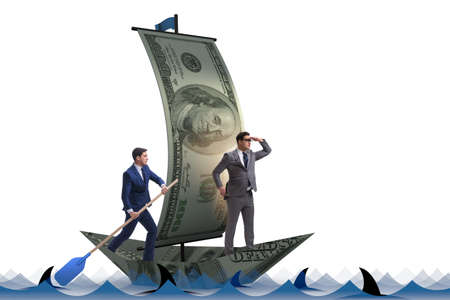 Businessman rowing on dollar boat in business financial conceptの写真素材