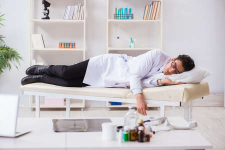 Doctor relaxing after complex surgery in hospitalの写真素材