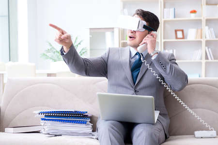 Businessman with virtual reality glasses in modern technology coの写真素材