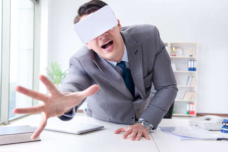 Businessman with virtual reality glasses in modern technology coの写真素材