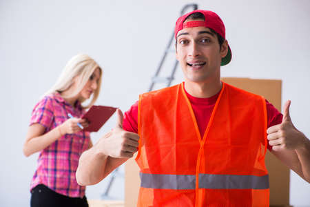 Young delivery assistant delivering to homeの写真素材
