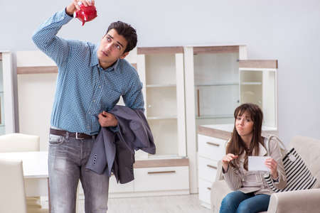 Young couple saving money for new furniture