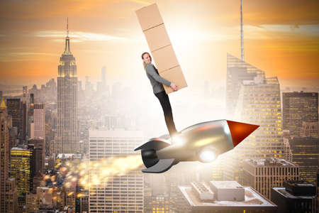Woman flying rocket and delivering boxesの写真素材