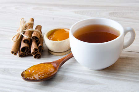 Cup of tea served with orange jamの写真素材
