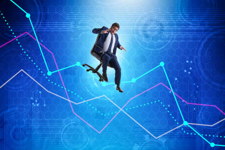 Businessman sliding down on chair in economic crisis conceptの写真素材