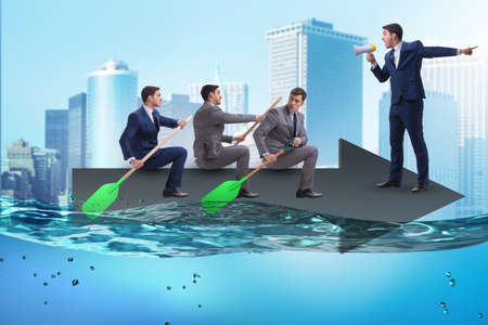 Teamwork concept with businessmen on boatの写真素材