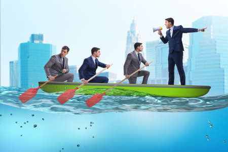 Team of businessmen in teamwork concept with boatの写真素材