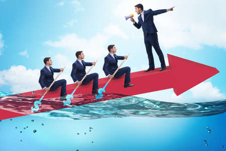 Teamwork concept with businessmen on boatの写真素材