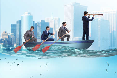Team of businessmen in teamwork concept with boatの写真素材