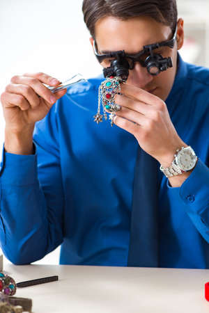 Jeweler working with luxury jewelry in the workshopの写真素材
