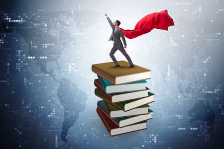 Superhero businessman  in education concept with booksの写真素材