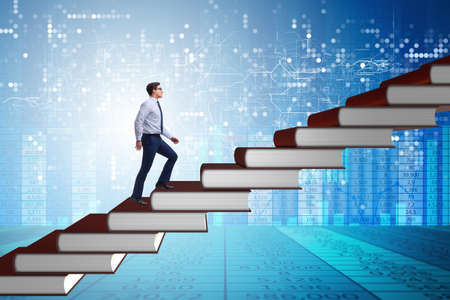 Businessman student climbing the ladder of education booksの写真素材