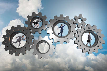Teamwork concept with cogwheels and business peopleの写真素材
