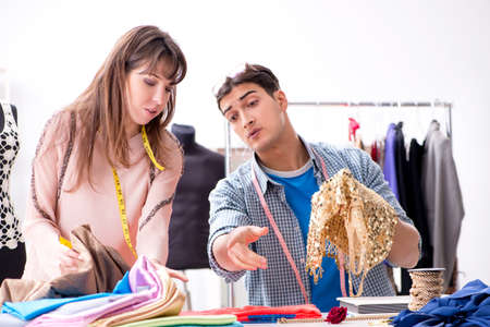 Male tailor with female student in workshop