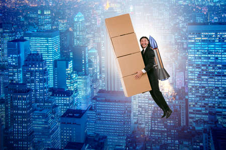 Businessman with jetpack delivering boxes globallyの写真素材