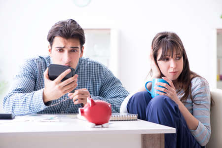 Young couple looking at family finance papersの写真素材