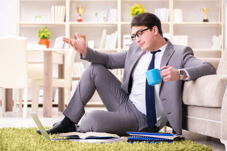 Businessman working on the floor at homeの写真素材