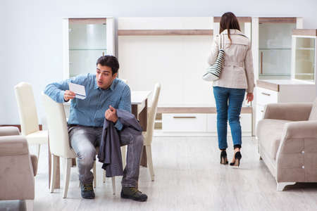 Young couple disappointed with price in furniture store