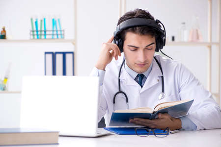 Male doctor listening to patient during telemedicine sessionの写真素材