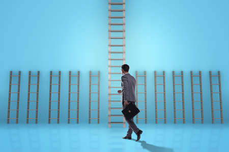 Businessman climbing career ladder in business success conceptの写真素材