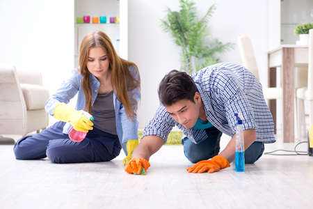 Young family cleaning the house