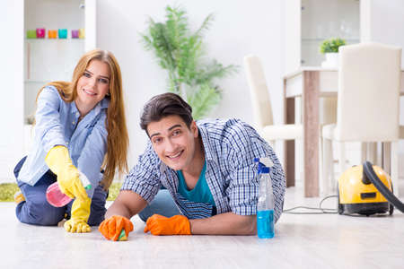 Young family cleaning the houseの写真素材