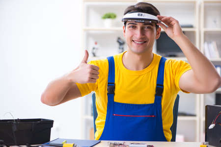 Computer repair technician repairing hardwareの写真素材