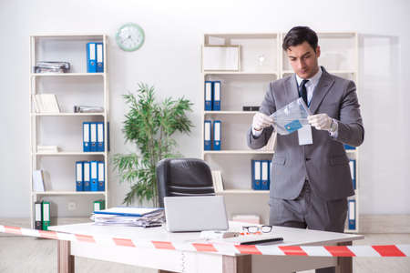 Forensics investigator at the scene of office crimeの写真素材