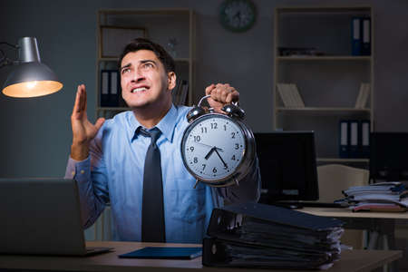 Young employee working overtime to meet deadlineの写真素材