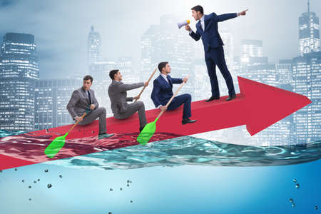 Teamwork concept with businessmen on boatの写真素材