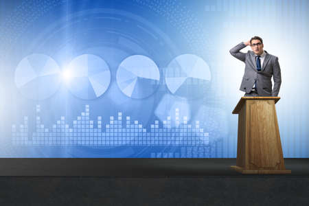 Man businessman making speech at rostrum in business conceptの写真素材
